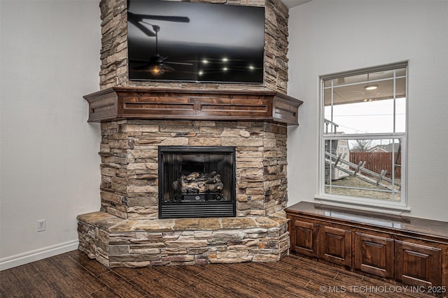 interior details with a fireplace and ceiling fan