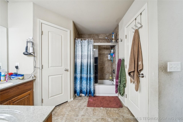 full bath with tile patterned flooring, shower / bath combo with shower curtain, and vanity