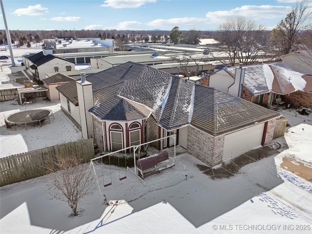 snowy aerial view featuring a residential view