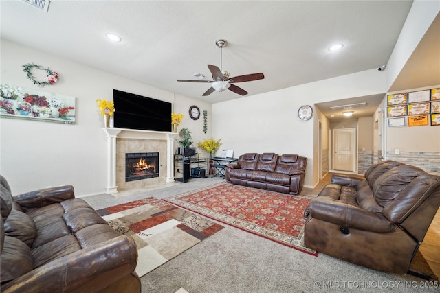 carpeted living area featuring a fireplace, visible vents, a ceiling fan, and recessed lighting