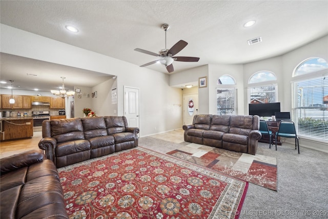 living room featuring visible vents, light colored carpet, ceiling fan with notable chandelier, a textured ceiling, and recessed lighting