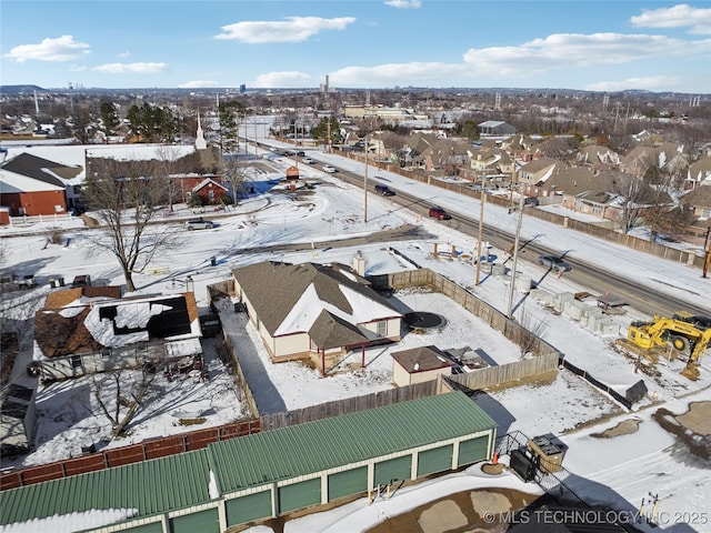 snowy aerial view featuring a residential view