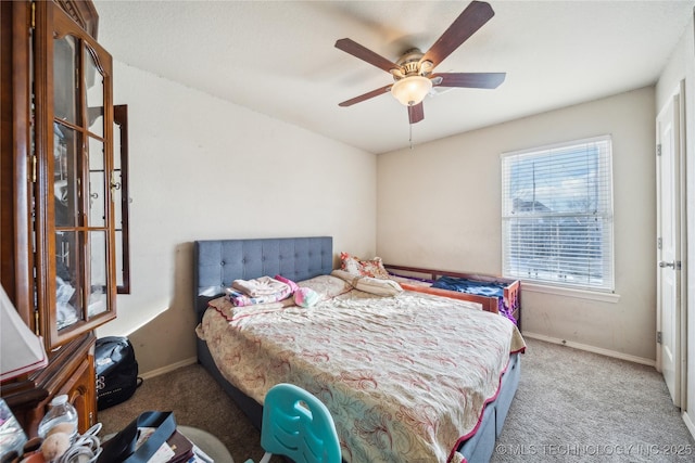 bedroom featuring ceiling fan, baseboards, and light colored carpet