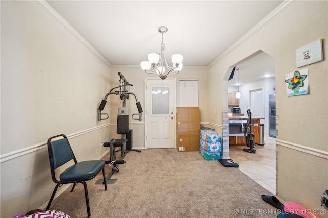 workout area featuring ornamental molding, light colored carpet, a notable chandelier, and light tile patterned flooring