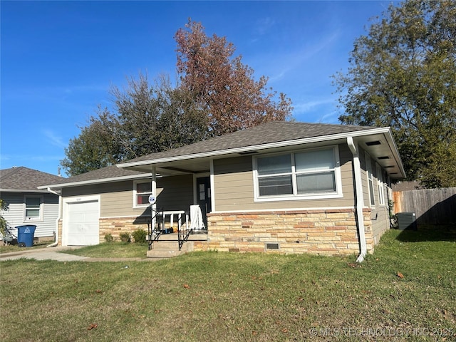 view of front of house featuring a front lawn, a garage, and central air condition unit