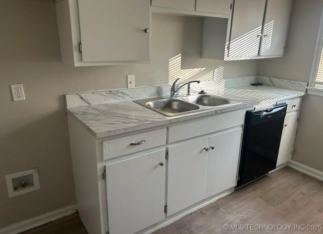 kitchen featuring sink, white cabinets, dishwasher, and light hardwood / wood-style flooring