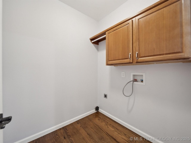 laundry room featuring dark wood-type flooring, hookup for an electric dryer, hookup for a washing machine, and cabinets