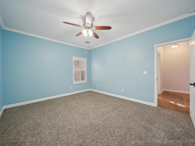 carpeted spare room featuring ceiling fan and ornamental molding