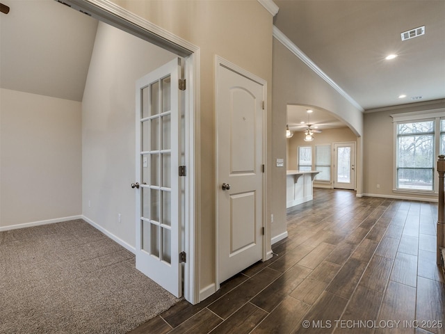 corridor with crown molding and vaulted ceiling