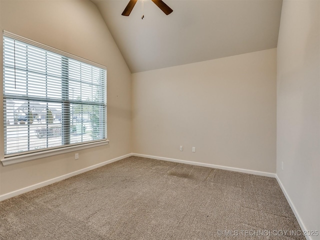 empty room with lofted ceiling, ceiling fan, and carpet floors