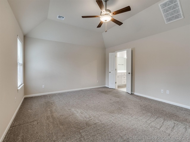 carpeted empty room with ceiling fan and vaulted ceiling