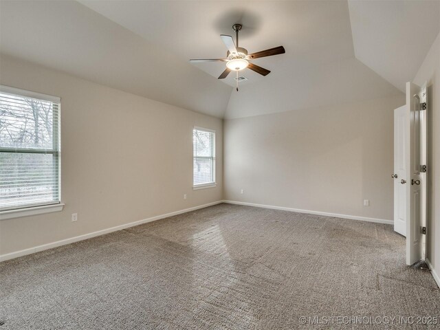 unfurnished room with lofted ceiling, ceiling fan, and carpet flooring