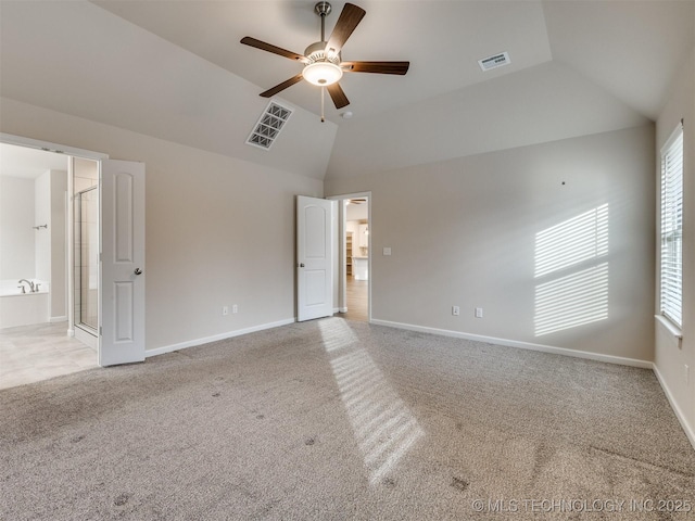 empty room with light carpet, ceiling fan, and vaulted ceiling