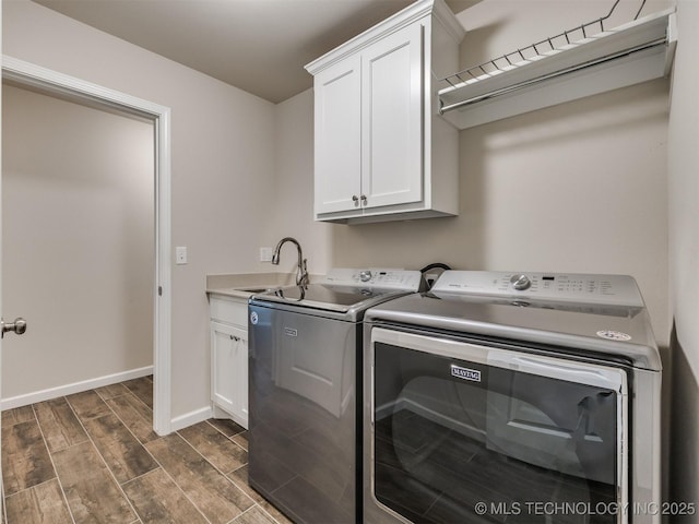 laundry room with independent washer and dryer, sink, and cabinets