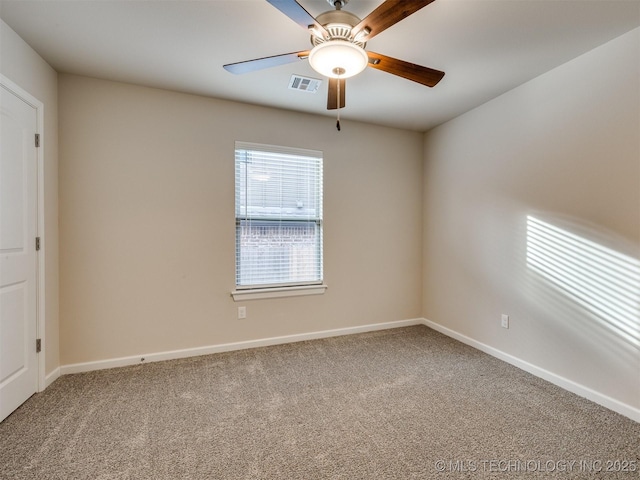 spare room featuring ceiling fan and carpet flooring