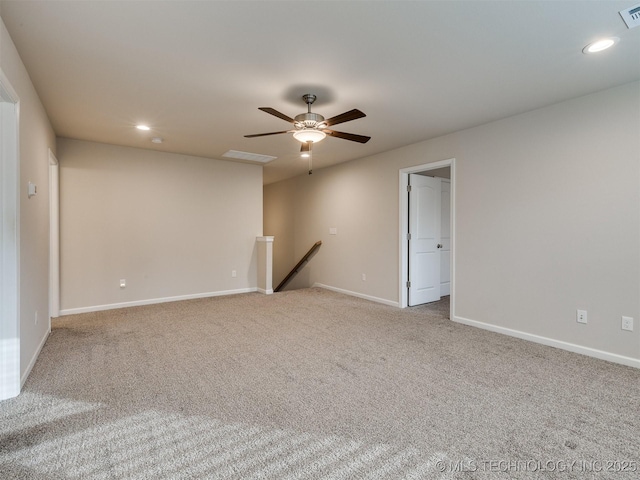 empty room featuring ceiling fan and light carpet