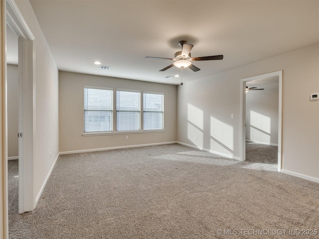 unfurnished room featuring ceiling fan and light colored carpet