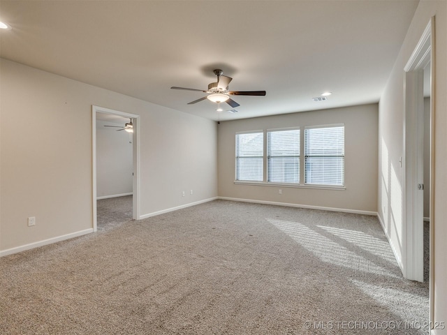 unfurnished room featuring ceiling fan and light colored carpet