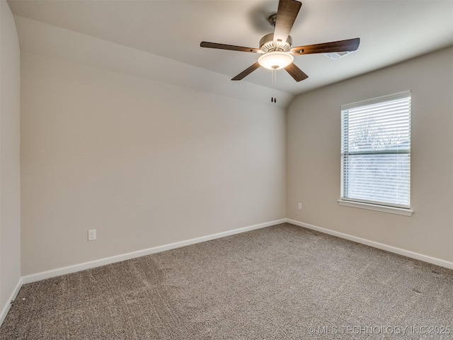 carpeted empty room with ceiling fan and lofted ceiling