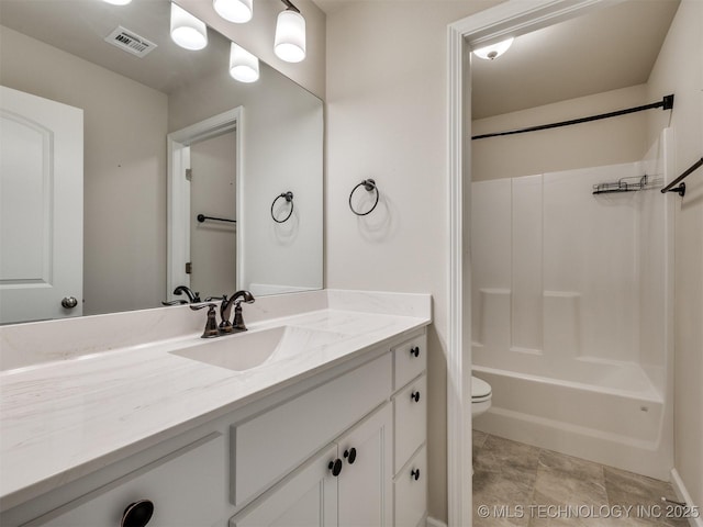 full bathroom featuring toilet, vanity, and washtub / shower combination