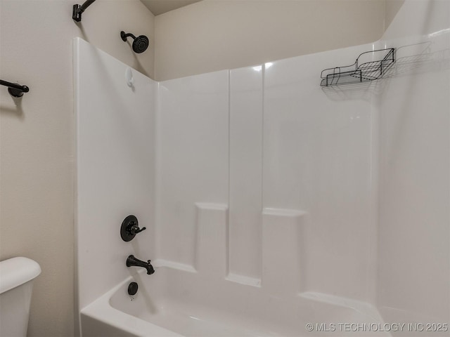 bathroom featuring toilet and  shower combination