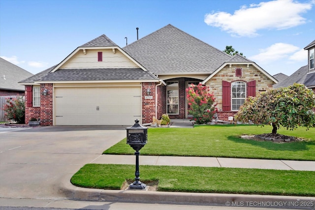 view of front of property with a front yard and a garage