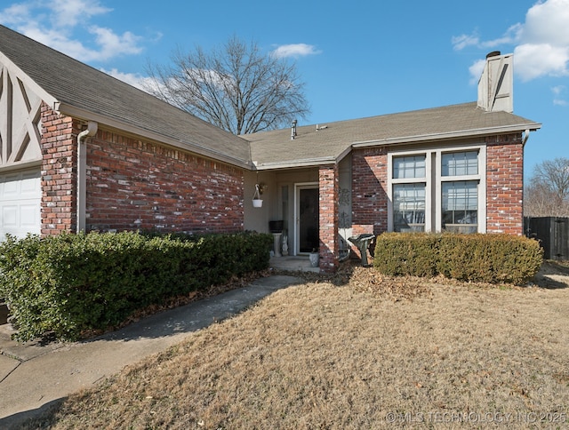 property entrance with a garage and a yard