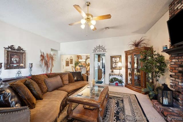 carpeted living room with ceiling fan and a textured ceiling