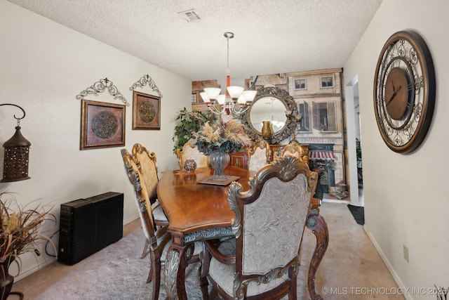 carpeted dining area featuring an inviting chandelier and a textured ceiling