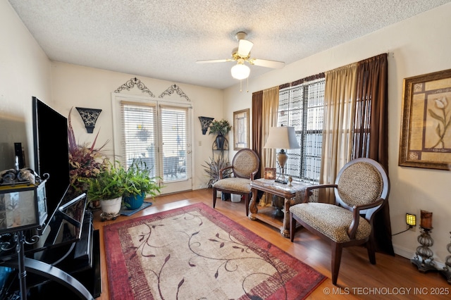 interior space featuring ceiling fan, hardwood / wood-style floors, and a textured ceiling