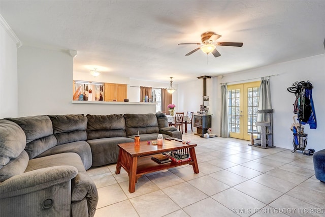 tiled living room featuring ceiling fan, ornamental molding, a healthy amount of sunlight, and french doors