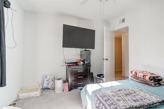 bedroom with ceiling fan and light carpet