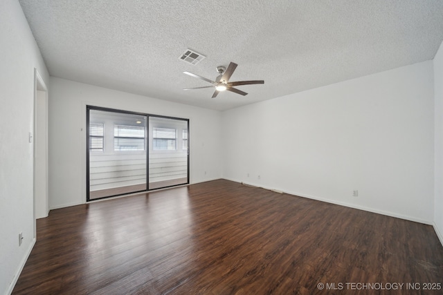 empty room featuring ceiling fan, a textured ceiling, and dark hardwood / wood-style flooring