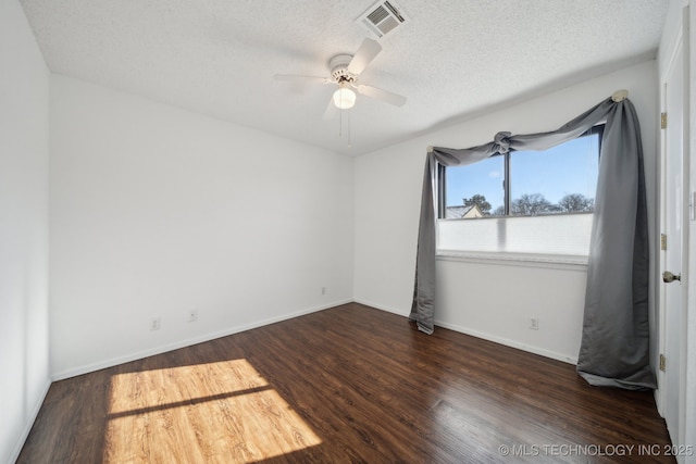 unfurnished room with a textured ceiling, dark hardwood / wood-style floors, and ceiling fan