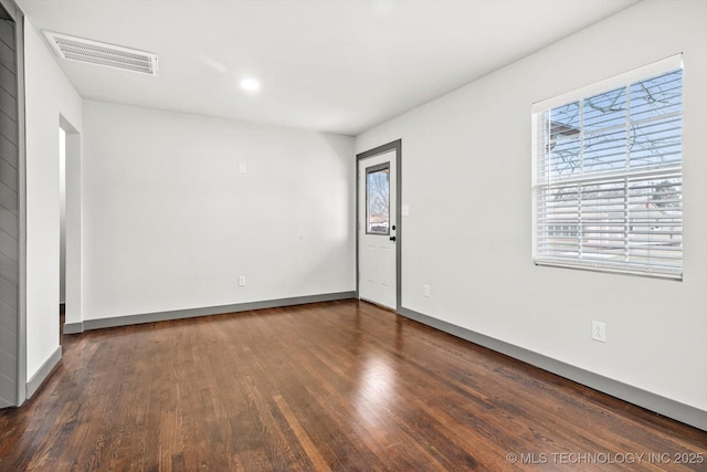 empty room featuring dark wood-type flooring