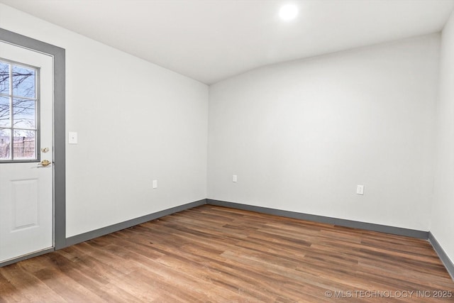 spare room featuring dark hardwood / wood-style floors