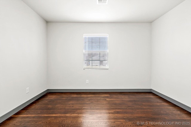 unfurnished room featuring dark hardwood / wood-style flooring