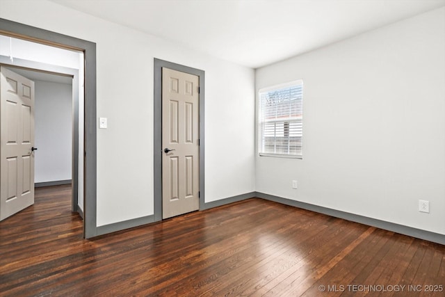 unfurnished bedroom featuring dark hardwood / wood-style flooring