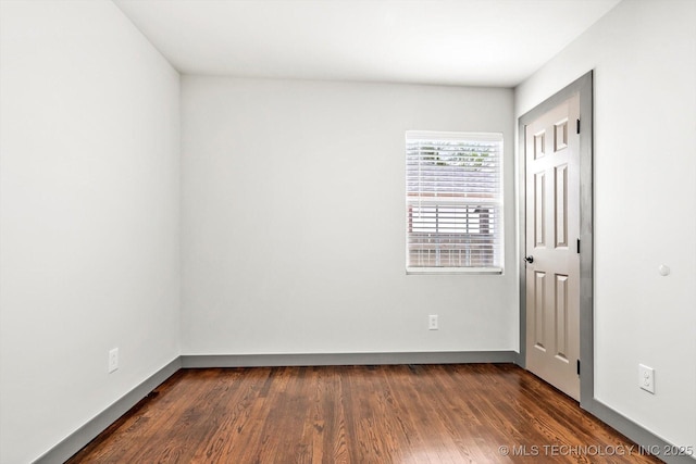 empty room with dark wood-type flooring