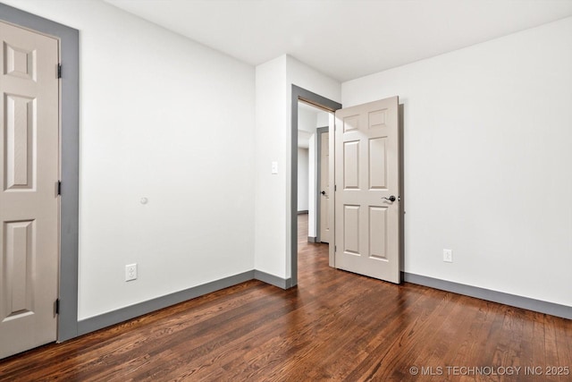 unfurnished bedroom featuring dark hardwood / wood-style floors