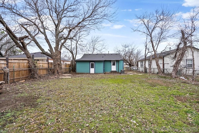 rear view of house with a yard