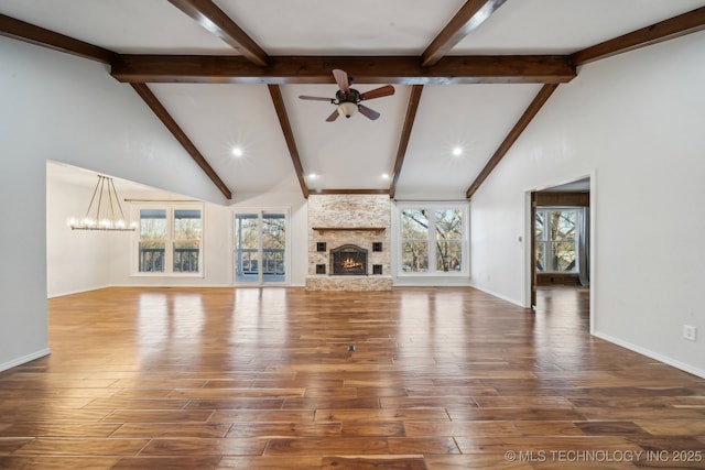 unfurnished living room featuring a fireplace, beam ceiling, high vaulted ceiling, hardwood / wood-style floors, and ceiling fan with notable chandelier