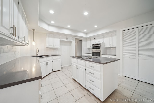 kitchen featuring a center island, sink, white cabinetry, light tile patterned floors, and double oven