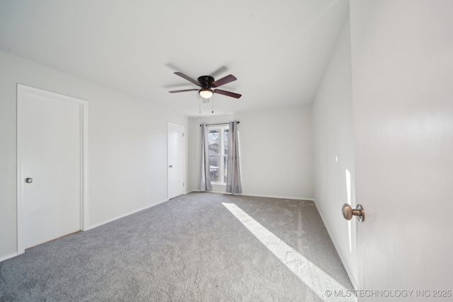 spare room with carpet floors and ceiling fan