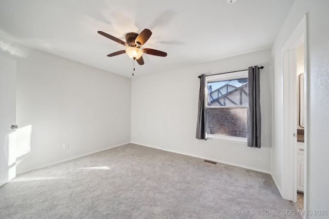 unfurnished room with ceiling fan and light colored carpet