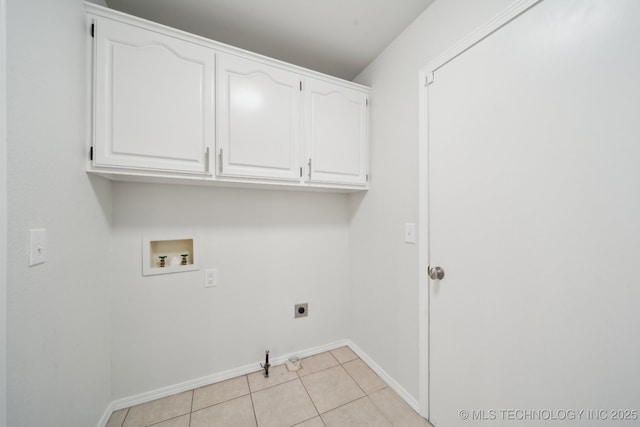 clothes washing area with cabinets, hookup for an electric dryer, hookup for a gas dryer, light tile patterned floors, and washer hookup