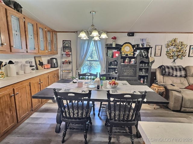 dining space with a chandelier and ornamental molding