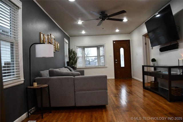 living room featuring dark hardwood / wood-style floors and ceiling fan