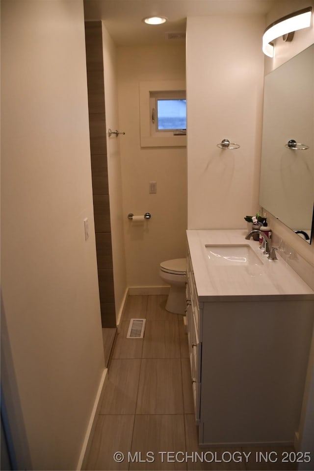 bathroom with toilet and vanity