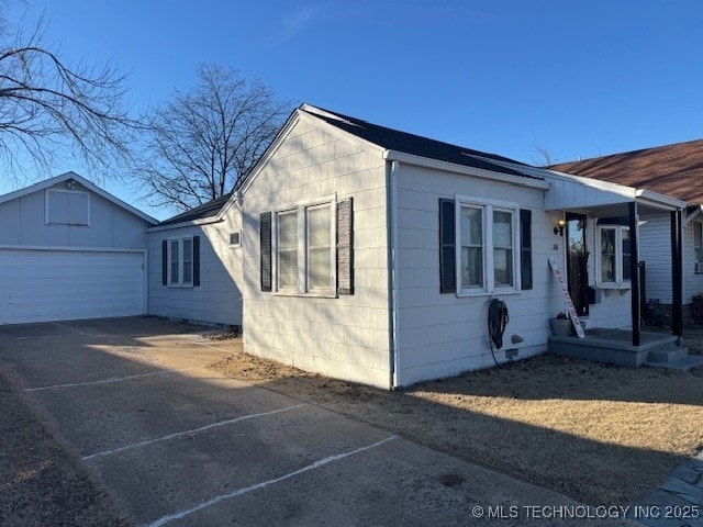 view of side of home with an outdoor structure and a garage